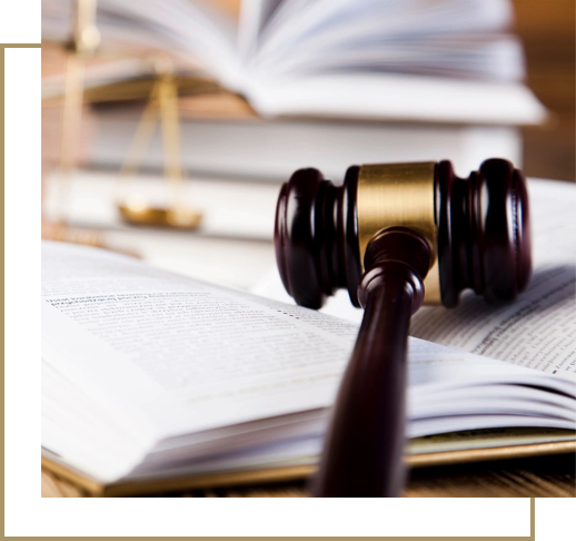 A judge 's gavel on top of an open book.